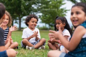 Preschool-aged children outdoors in a group learning activity