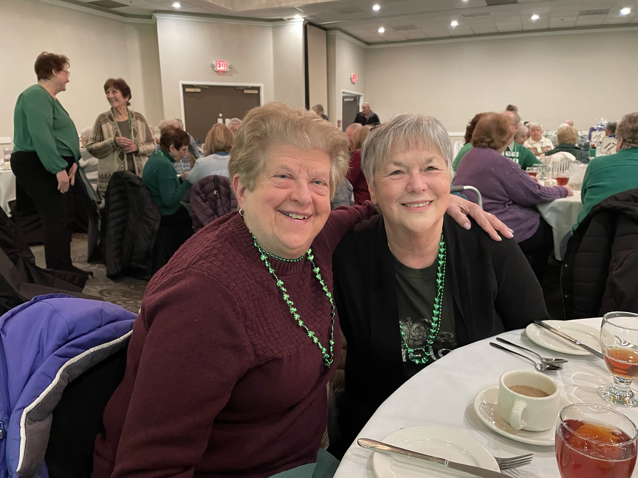Two women sitting at a table at the St. Patrick's day dinner