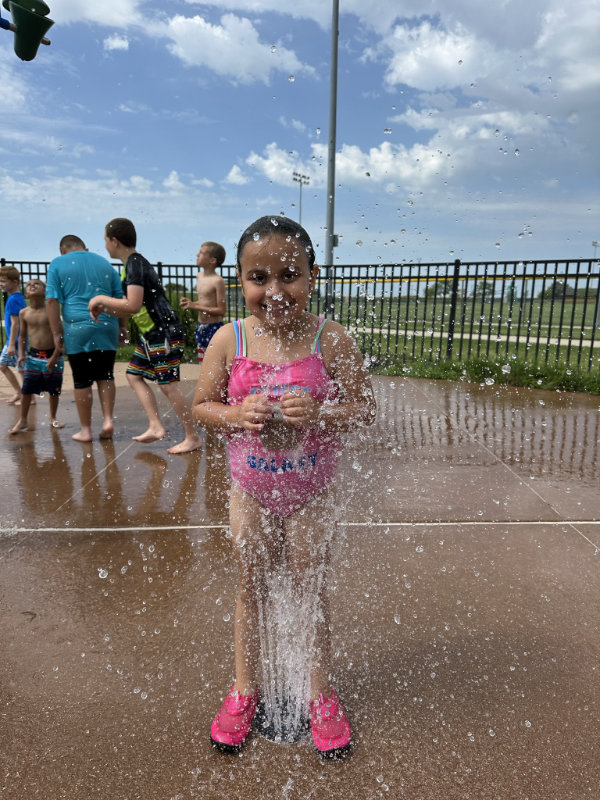 Child playing at a spray park