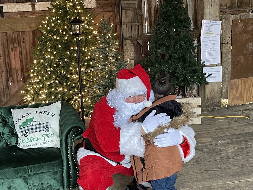 Picture of kid hugging Santa Claus